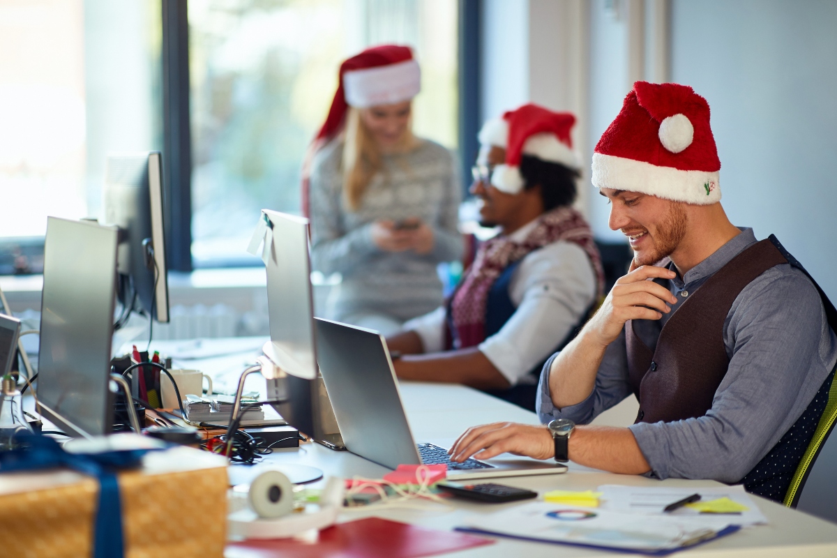 employees wearing christmas hats